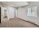 Spacious bedroom featuring neutral carpeting, ample natural light, and a walk-in closet for optimal storage at 14310 Kalamath St, Westminster, CO 80023