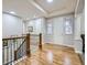 Hallway with hardwood floors and wrought iron railing on the staircase at 14310 Kalamath St, Westminster, CO 80023