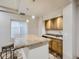 Charming kitchen featuring a granite countertop island and warm wood cabinetry providing ample storage at 14310 Kalamath St, Westminster, CO 80023