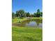 Picturesque pond surrounded by green grass and trees at 14310 Kalamath St, Westminster, CO 80023
