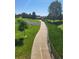 A scenic walkway with lush greenery and a bridge in the background at 14310 Kalamath St, Westminster, CO 80023