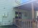View of the covered back porch and sliding glass door at 17477 E Temple Dr, Aurora, CO 80015