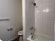 Bathroom showcasing a white tiled shower and bathtub, updated fixtures, and a clean aesthetic at 17477 E Temple Dr, Aurora, CO 80015