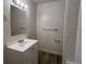 Bright bathroom featuring a white vanity, updated fixtures, and a shower with white tiling at 17477 E Temple Dr, Aurora, CO 80015