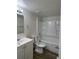 Clean bathroom with white fixtures, including a tub and vanity at 17477 E Temple Dr, Aurora, CO 80015