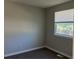 Sunlit bedroom with neutral paint, carpet, and a window with exterior view at 17477 E Temple Dr, Aurora, CO 80015