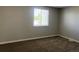 Inviting bedroom with neutral paint, carpet, and a window with exterior view at 17477 E Temple Dr, Aurora, CO 80015
