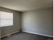 Bright bedroom with carpet, neutral paint, and a window with blinds at 17477 E Temple Dr, Aurora, CO 80015