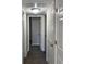 Hallway with neutral walls and white doors, offering access to various rooms at 17477 E Temple Dr, Aurora, CO 80015