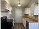 Functional kitchen features white cabinets, wood countertops, and updated appliances at 17477 E Temple Dr, Aurora, CO 80015