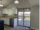 Cozy kitchen with modern appliances and a sliding glass door to the backyard deck at 17477 E Temple Dr, Aurora, CO 80015