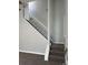 Carpeted staircase with white railing leads to upper level, great natural light at 17477 E Temple Dr, Aurora, CO 80015