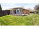 Expansive backyard with manicured lawn and access to the home's sunroom at 11223 W 29Th Ave, Lakewood, CO 80215