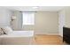 Bedroom with stylish paneled walls, light wood floors, and ample natural light coming in from the window at 11223 W 29Th Ave, Lakewood, CO 80215
