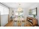 Bright dining room boasts hardwood floors and elegant lighting fixture at 11223 W 29Th Ave, Lakewood, CO 80215