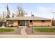 Charming brick ranch home featuring a manicured front yard, tasteful landscaping and a welcoming walkway at 11223 W 29Th Ave, Lakewood, CO 80215