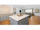 Open kitchen offers lots of natural light, island with seating, and easy access to the living room at 11223 W 29Th Ave, Lakewood, CO 80215