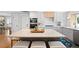 Spacious kitchen island with marble countertop, barstool seating, and ample storage at 11223 W 29Th Ave, Lakewood, CO 80215