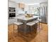 Stylish kitchen featuring stainless steel appliances, a center island, and classic gray cabinets at 11223 W 29Th Ave, Lakewood, CO 80215