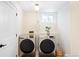 Efficient laundry room with modern front-load washer and dryer, ample lighting, and clean, minimalist design at 11223 W 29Th Ave, Lakewood, CO 80215