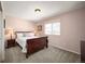 Cozy bedroom with a comfortable bed, side tables, and natural light from the window at 24749 E Florida Ave, Aurora, CO 80018