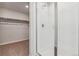 This bathroom features a walk-in shower, white tile and a walk-in closet nearby at 5784 Farmstead Pl, Mead, CO 80504