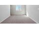 Neutral bedroom with window offering a view of the mountains and beige carpet at 5784 Farmstead Pl, Mead, CO 80504
