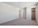 Simple bedroom with neutral paint, carpet, closet and access to a closet at 5784 Farmstead Pl, Mead, CO 80504