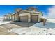 Two-story home featuring a two car garage and a lawn covered with snow at 5784 Farmstead Pl, Mead, CO 80504