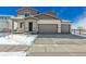 Two-story home featuring a two car garage, covered porch, and winter lawn at 5784 Farmstead Pl, Mead, CO 80504
