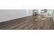 Spacious living area featuring luxury vinyl flooring and modern finishes at 5784 Farmstead Pl, Mead, CO 80504