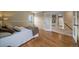 Spacious bedroom with hardwood floors and access to a shared bathroom at 2151 E 99Th Pl, Thornton, CO 80229