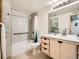 Updated bathroom with a shower/tub combo and modern vanity at 400 Zang St # 1-105, Lakewood, CO 80228