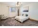 Bright bedroom with a queen-size bed, carpet flooring, and ceiling fan at 400 Zang St # 1-105, Lakewood, CO 80228