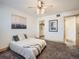 Bright bedroom featuring comfortable carpet, ceiling fan and access to closet and bathroom at 400 Zang St # 1-105, Lakewood, CO 80228