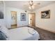 Inviting bedroom with warm color palette, ceiling fan and access to other parts of the home at 400 Zang St # 1-105, Lakewood, CO 80228