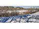 Scenic winter view of the community with snow-covered ground and mature trees at 400 Zang St # 1-105, Lakewood, CO 80228