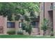 Charming exterior of a multi-Gathering home with well-maintained lawn and mature trees at 400 Zang St # 1-105, Lakewood, CO 80228