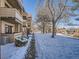 Apartment building in winter with a snowy path and bare trees; good walkability to nearby neighborhoods at 400 Zang St # 1-105, Lakewood, CO 80228