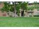 Charming exterior of a multi-Gathering home with well-maintained lawn and mature trees at 400 Zang St # 1-105, Lakewood, CO 80228