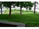 A view from the porch to a green lawn with mature trees at 400 Zang St # 1-105, Lakewood, CO 80228