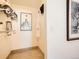 Bright hallway featuring tile flooring, artwork, and closet space with shelving and a hanging rack at 400 Zang St # 1-105, Lakewood, CO 80228