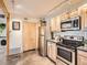 Updated kitchen features stainless steel appliances and custom cabinetry, maximizing space at 400 Zang St # 1-105, Lakewood, CO 80228