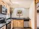 Bright kitchen featuring updated appliances, light backsplash and faucet details at 400 Zang St # 1-105, Lakewood, CO 80228
