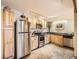 Well-lit kitchen with light wood cabinetry and stainless steel appliances for a modern feel at 400 Zang St # 1-105, Lakewood, CO 80228