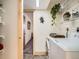 Laundry room with washer, dryer, and wire shelving, located next to a doorway with a view to another room at 400 Zang St # 1-105, Lakewood, CO 80228