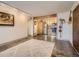 View of open living room to the modern kitchen; track lighting and light color scheme at 400 Zang St # 1-105, Lakewood, CO 80228