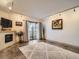 Bright living room featuring a fireplace, balcony access, and contemporary furnishings at 400 Zang St # 1-105, Lakewood, CO 80228