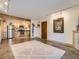 Open-concept living room featuring an adjacent kitchen, modern furnishings, and stylish decor at 400 Zang St # 1-105, Lakewood, CO 80228