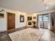 Bright living room featuring a fireplace, balcony access, and contemporary furnishings at 400 Zang St # 1-105, Lakewood, CO 80228